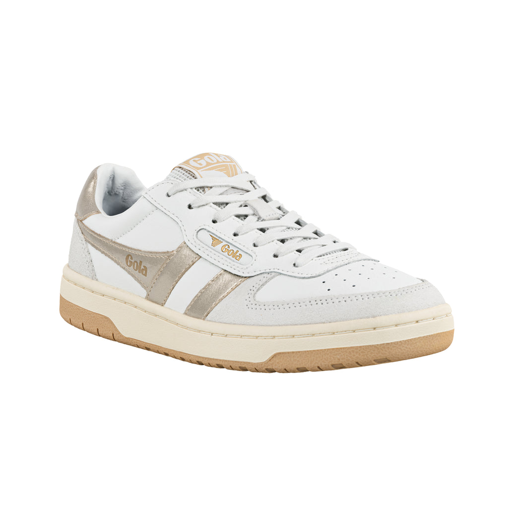 White Gola trainer with metallic gold side stripes and gum sole