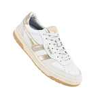 White Gola trainer with metallic gold side stripes and a gum rubber sole