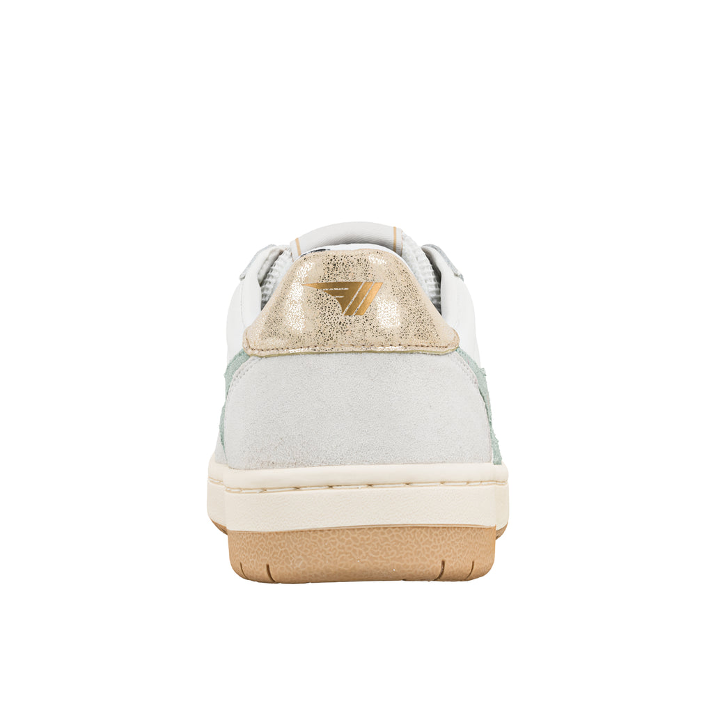 Rear view of white trainer with metallic gold heel tab and gum rubber sole