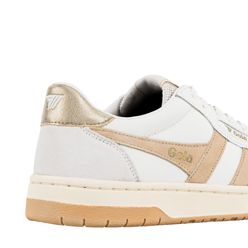 Close up of white and beige Gola trainer heel with metallic gold detailing
