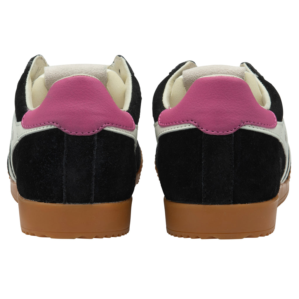 Black and white trainers with pink heel tab on a white background