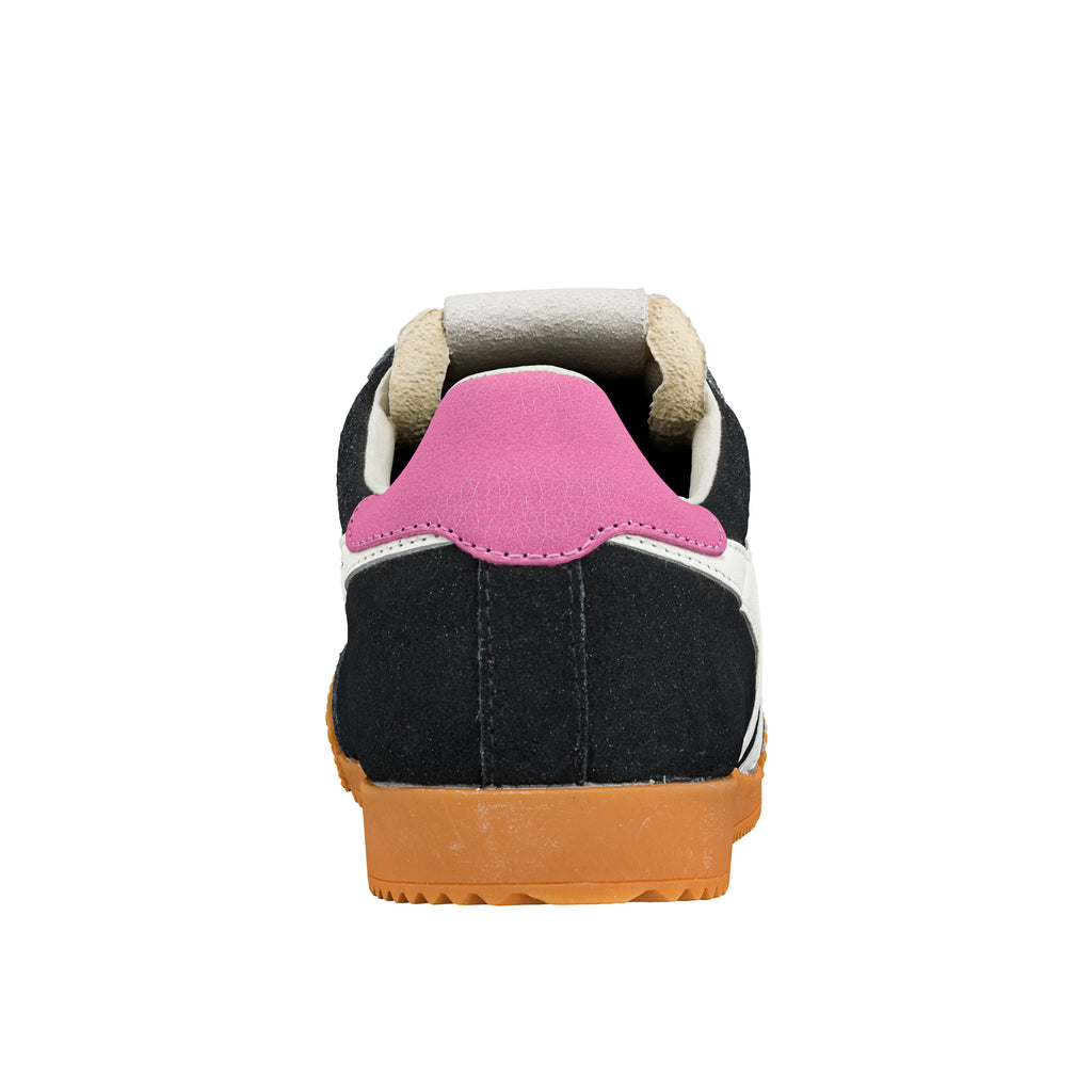 Rear view of a black suede trainer with a pink heel tab and gum rubber sole