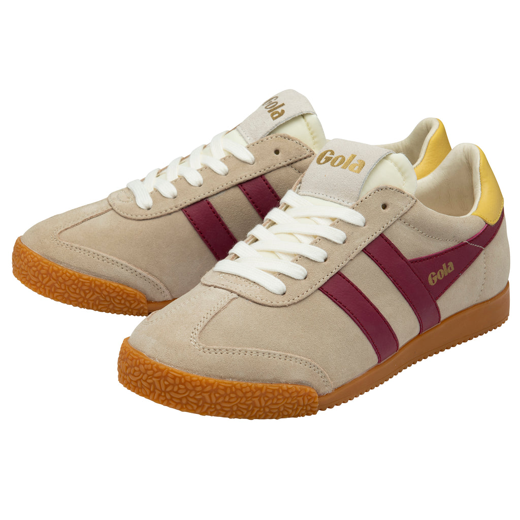Beige trainers with maroon stripes and brown soles on a white background