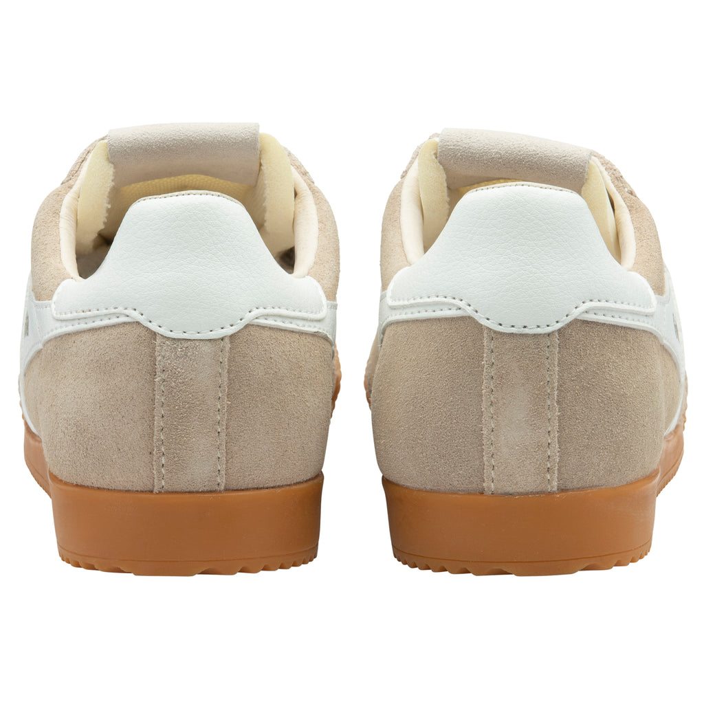 Pair of beige trainers with white soles on a white background