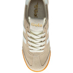 Beige trainer with white laces on a white background