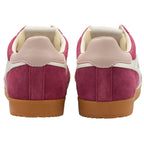Pair of pink trainers with beige soles on a white background
