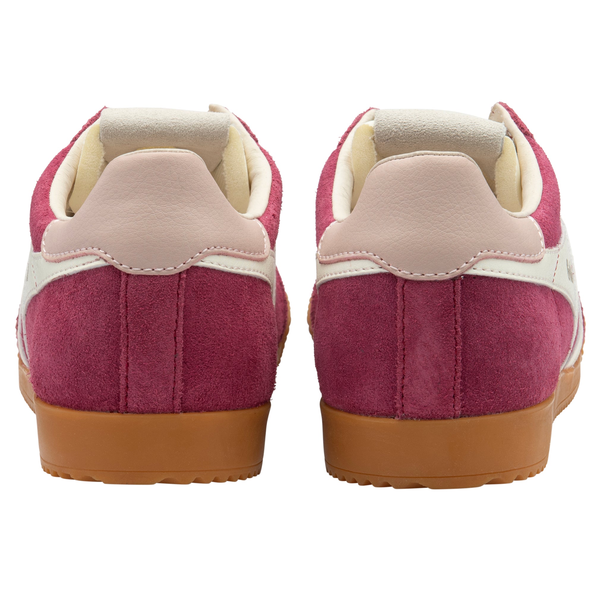 Pair of pink trainers with beige soles on a white background