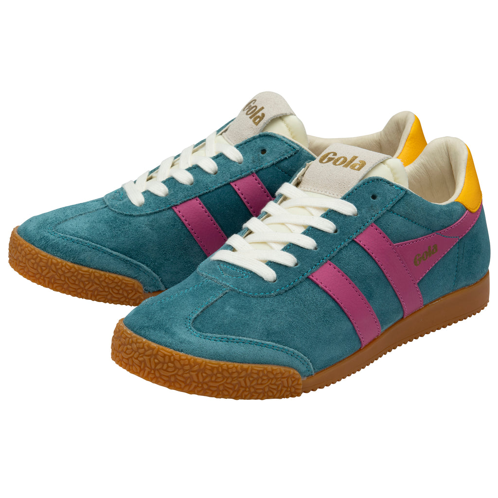 Blue trainers with pink stripes and gum soles on a white background