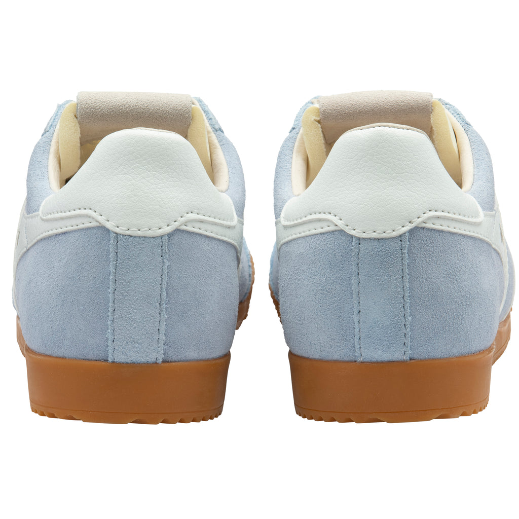 Pair of light blue trainers with gum soles on a white background