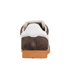 Rear view of a brown suede trainer with a white heel tab and gum rubber sole
