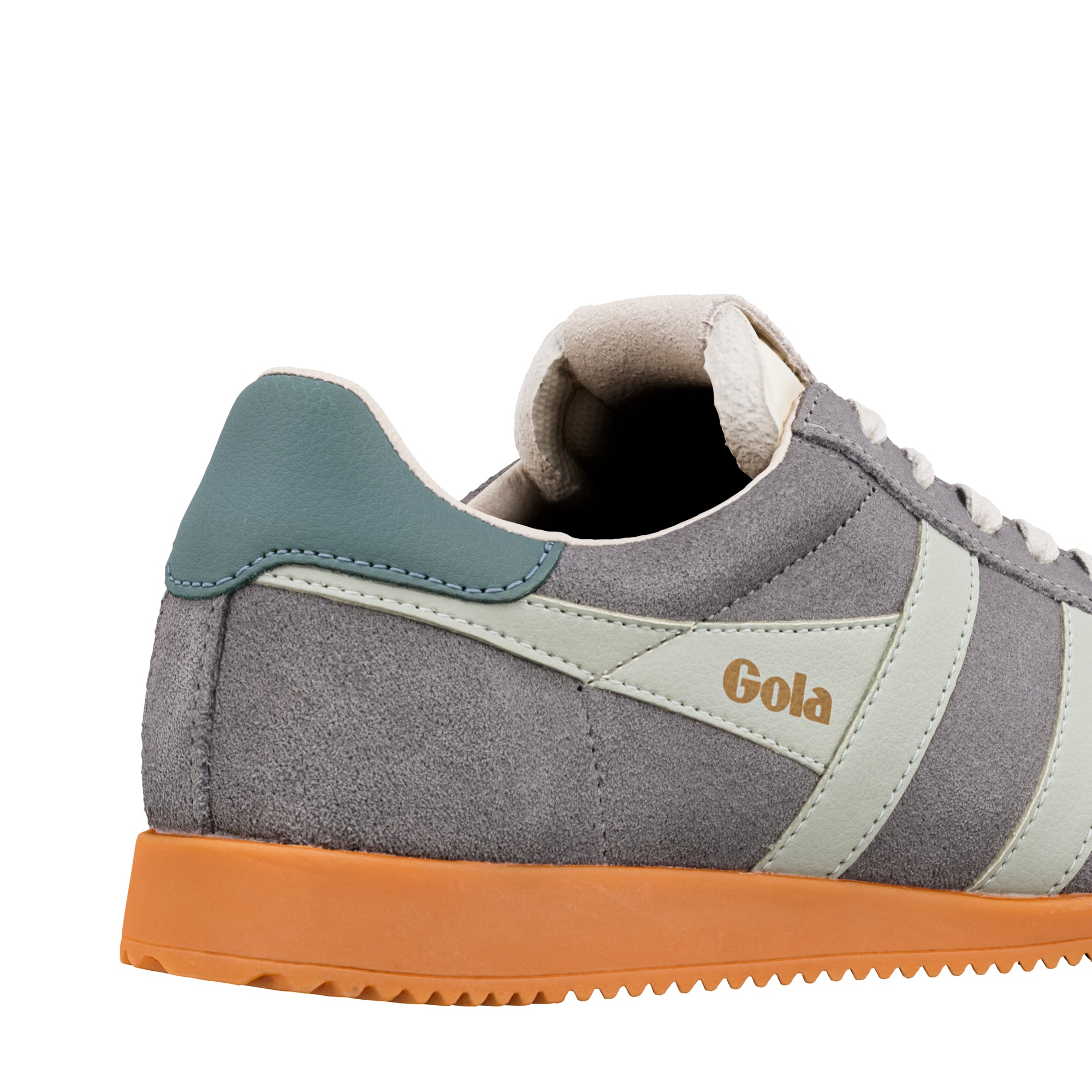 Close up of grey suede Gola trainer with teal heel tab and orange rubber sole