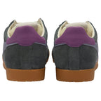 Pair of grey trainers with purple heel tab on a white background