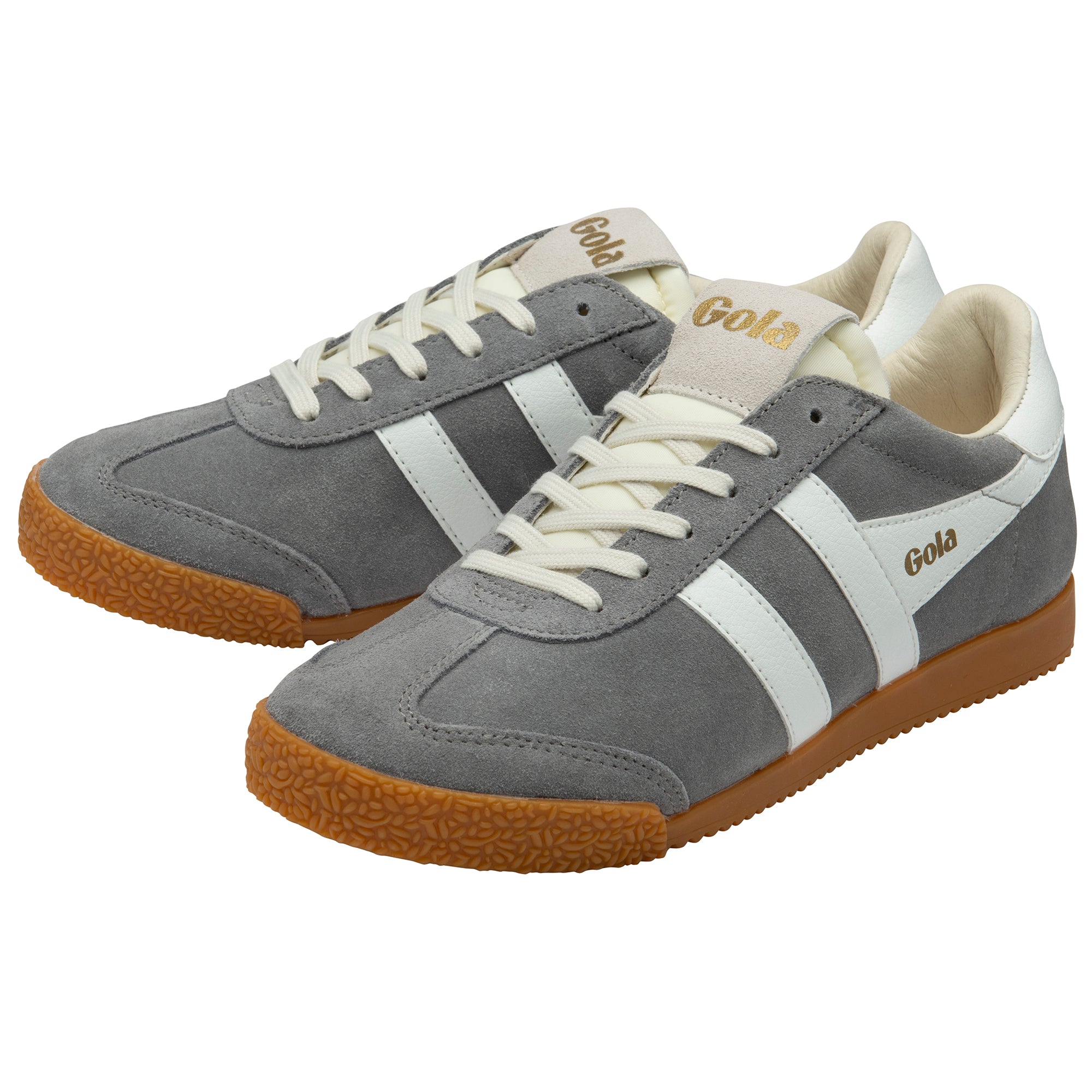 Pair of grey trainers with white stripes and brown soles on a white background