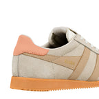Close up of the heel and side panel of a beige suede Gola trainer with a peach heel tab and orange sole