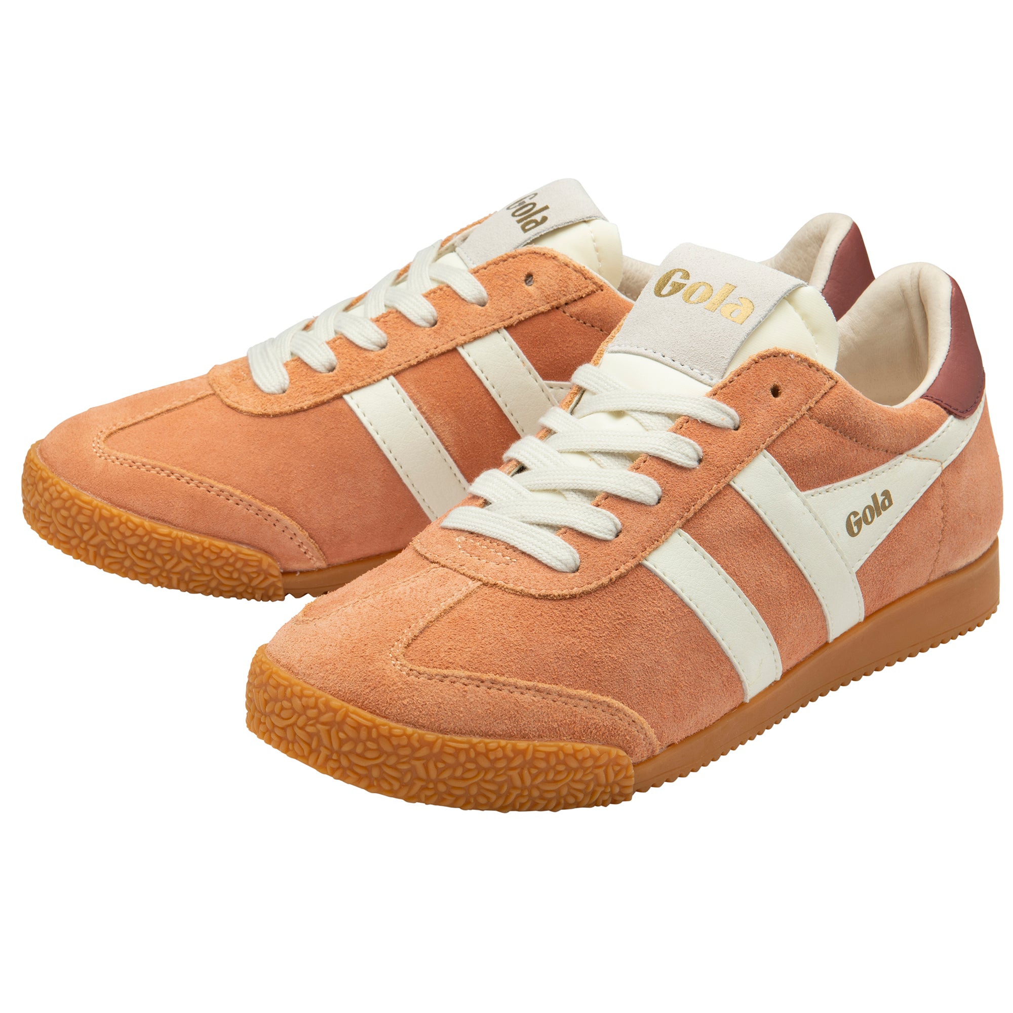 Pair of tan trainers with white stripes and laces on a white background