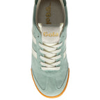 Green trainer with white laces on a white background