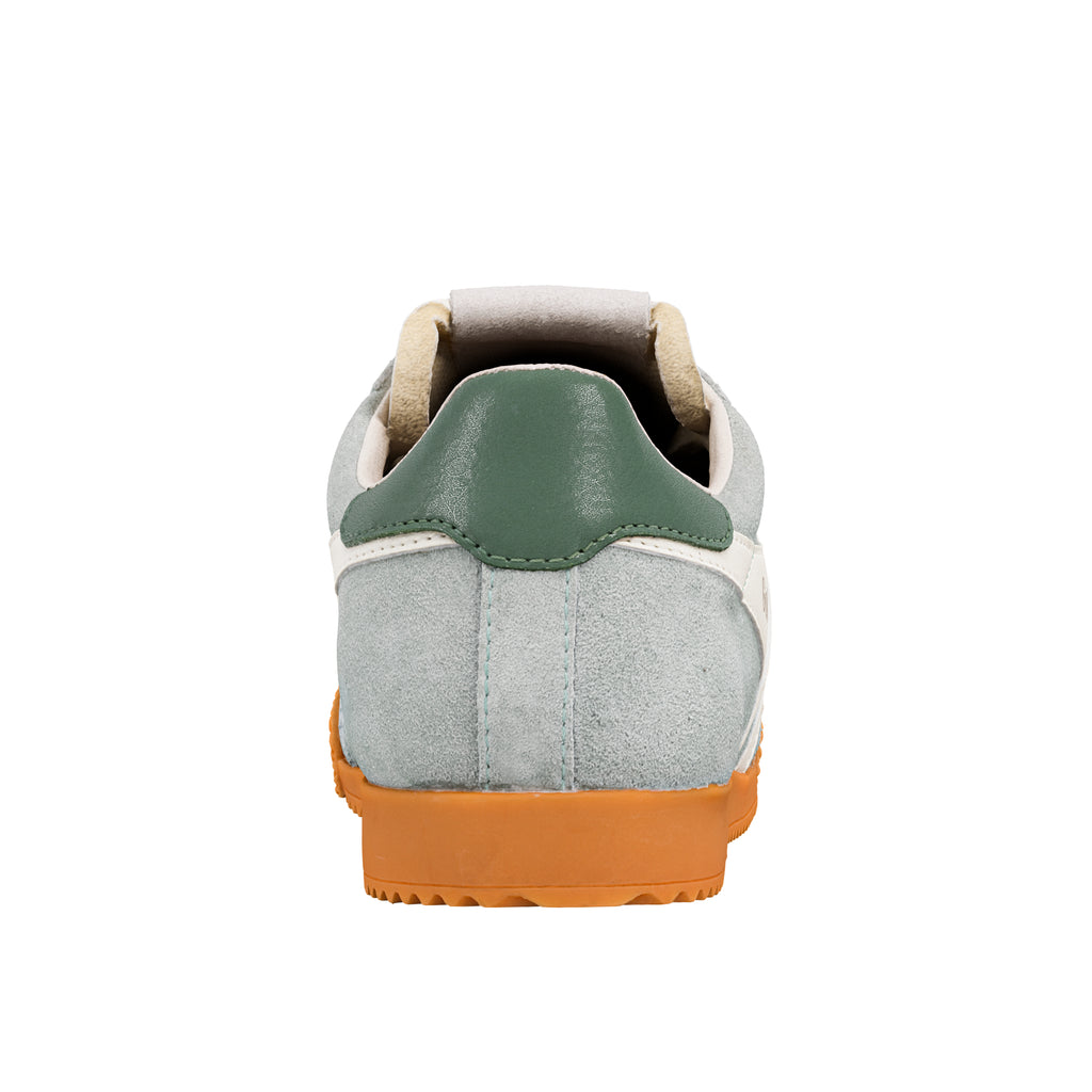 Rear view of a light grey suede trainer with a green heel tab and orange rubber sole