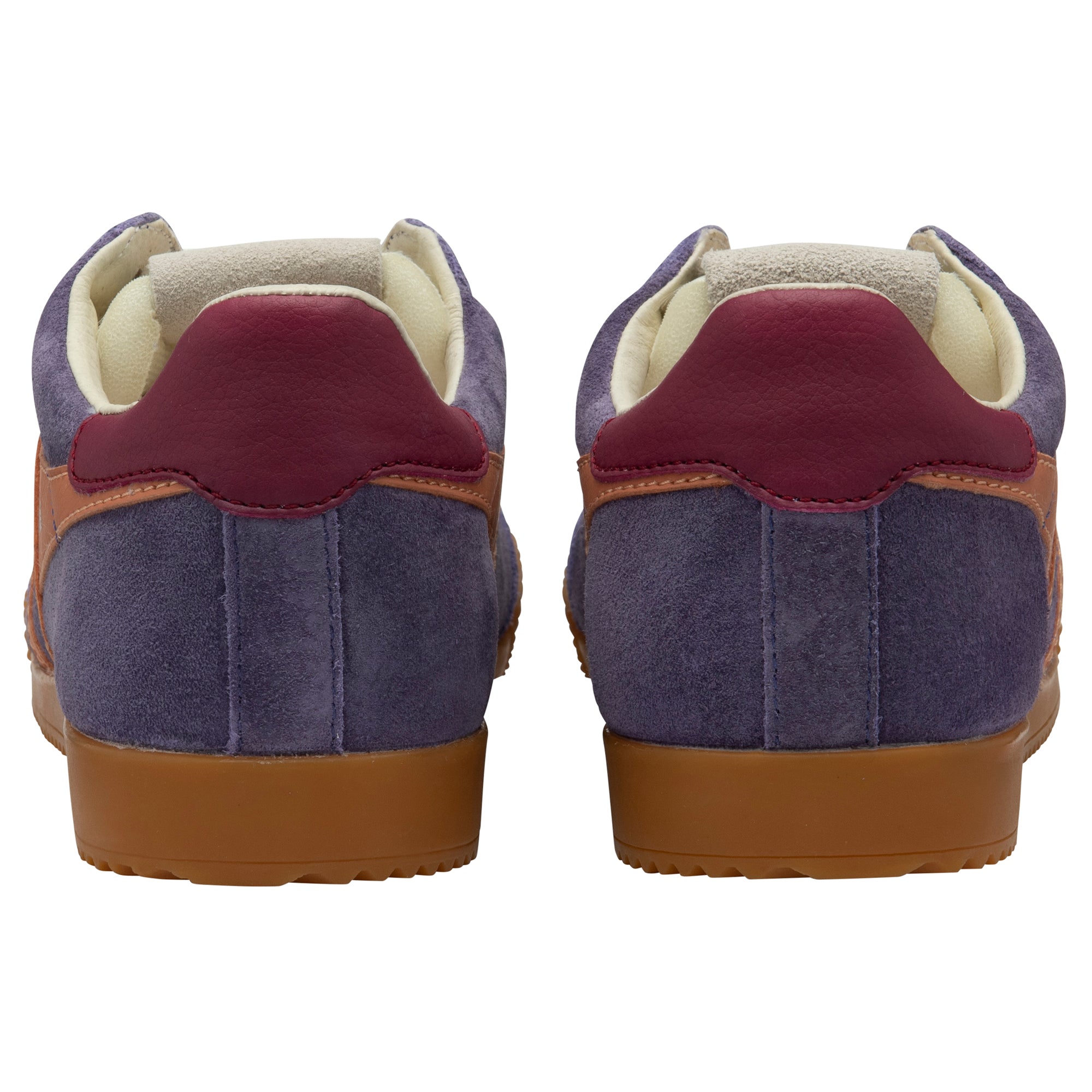 Purple trainers with red accents on a white background