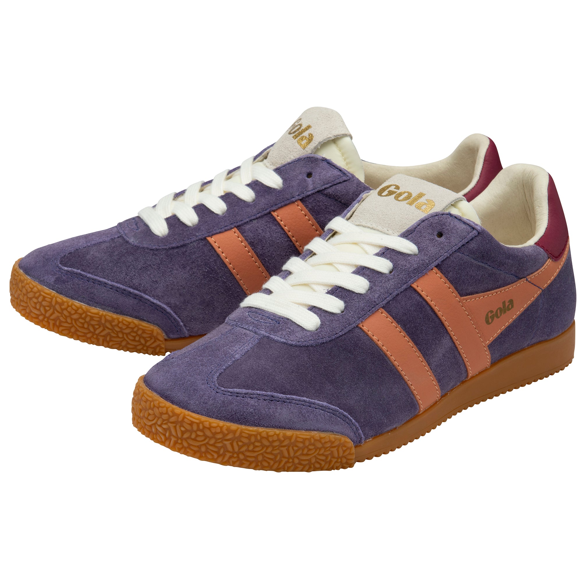 Purple trainers with orange accents and white laces on a white background