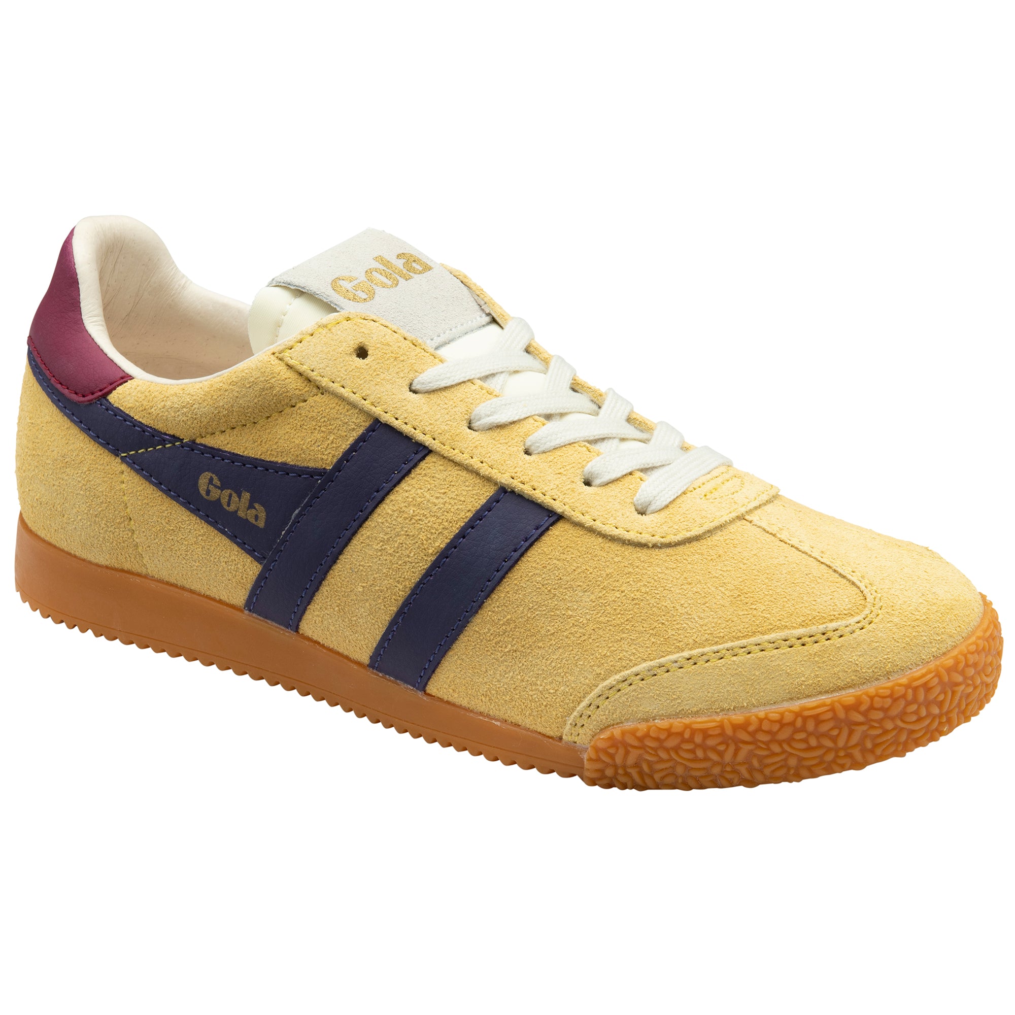 Yellow trainer with navy stripes and gum sole on a white background