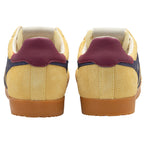 Pair of trainers with a gum sole and purple heel tab on a white background