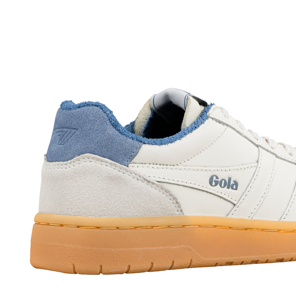 Close up of the heel of a white Gola trainer with a blue suede heel tab and a gum sole