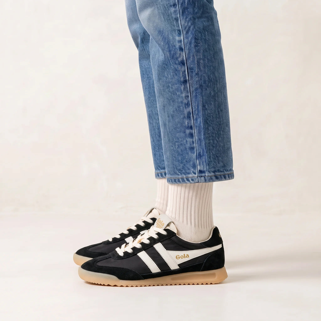 Gola Classics black and white trainers with gum sole worn with blue jeans and white socks