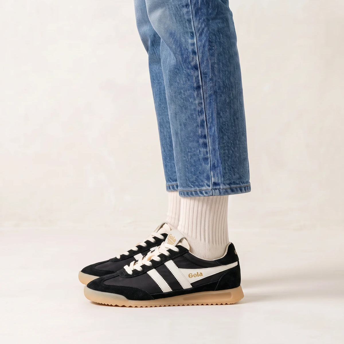 Gola Classics black and white trainers with gum sole worn with blue jeans and white socks