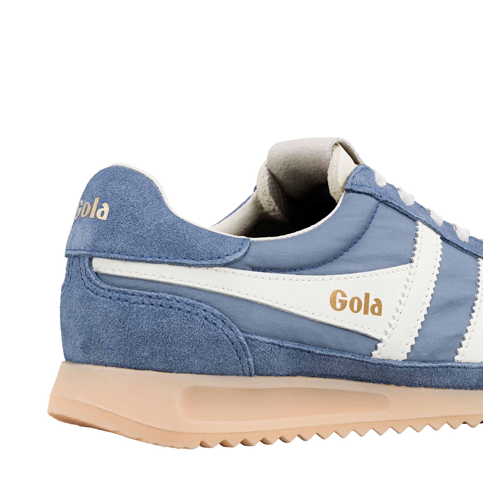 Close-up of a Gola trainer in blue with white stripes and a beige sole