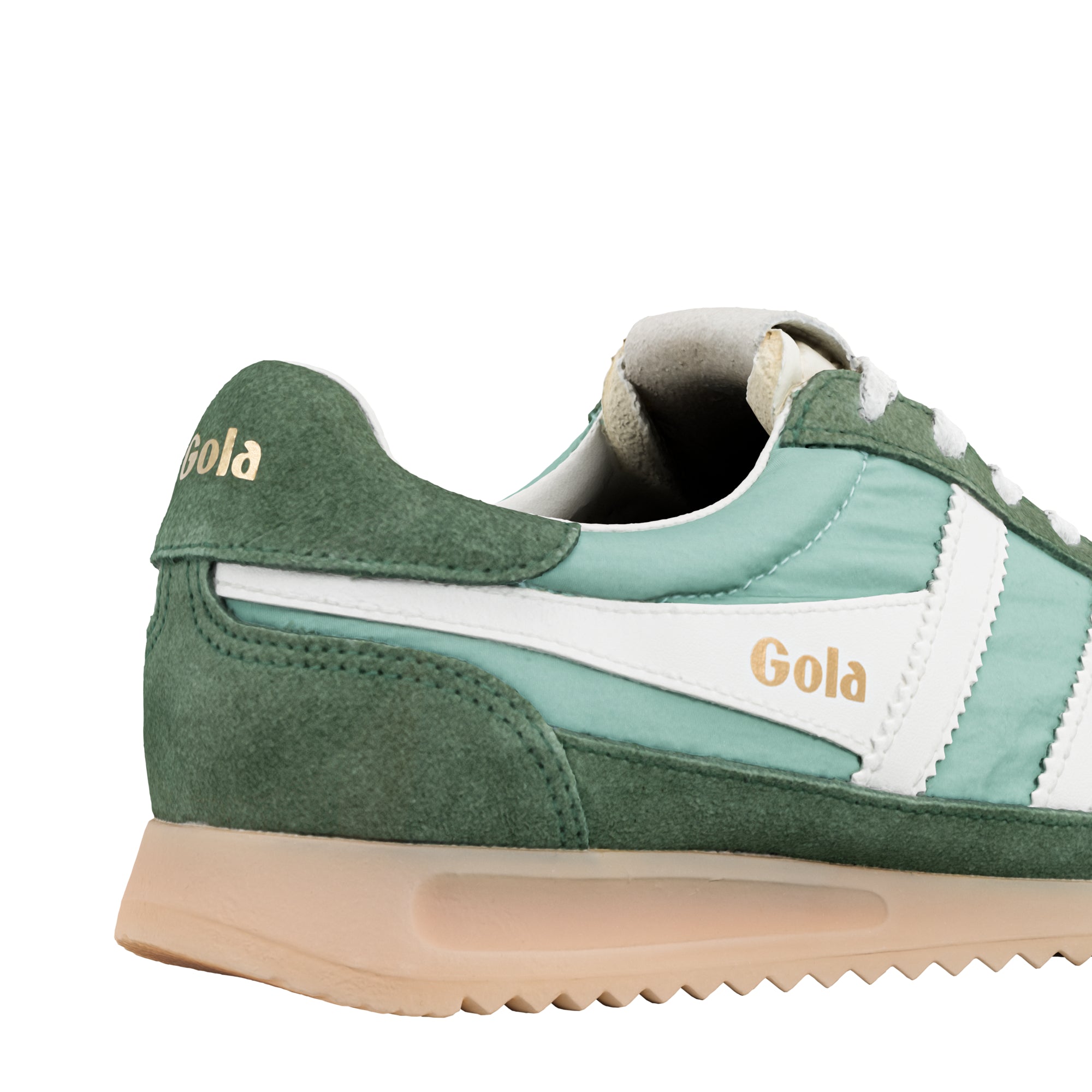 Close up of the back of a green and white Gola trainer with a beige sole