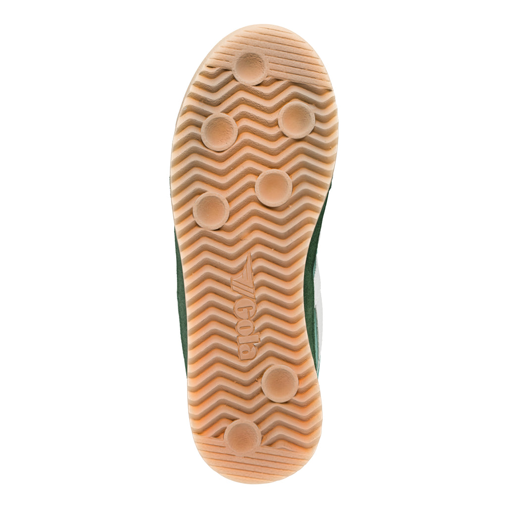 Underside of a green trainer with a light brown sole, featuring a wavy pattern and circular grips
