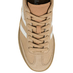 Top view of a beige suede Gola trainer with white side stripes and matching laces