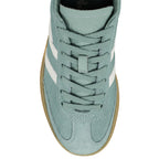 Top view of a sage green suede Gola trainer with white side stripes and a gum rubber sole