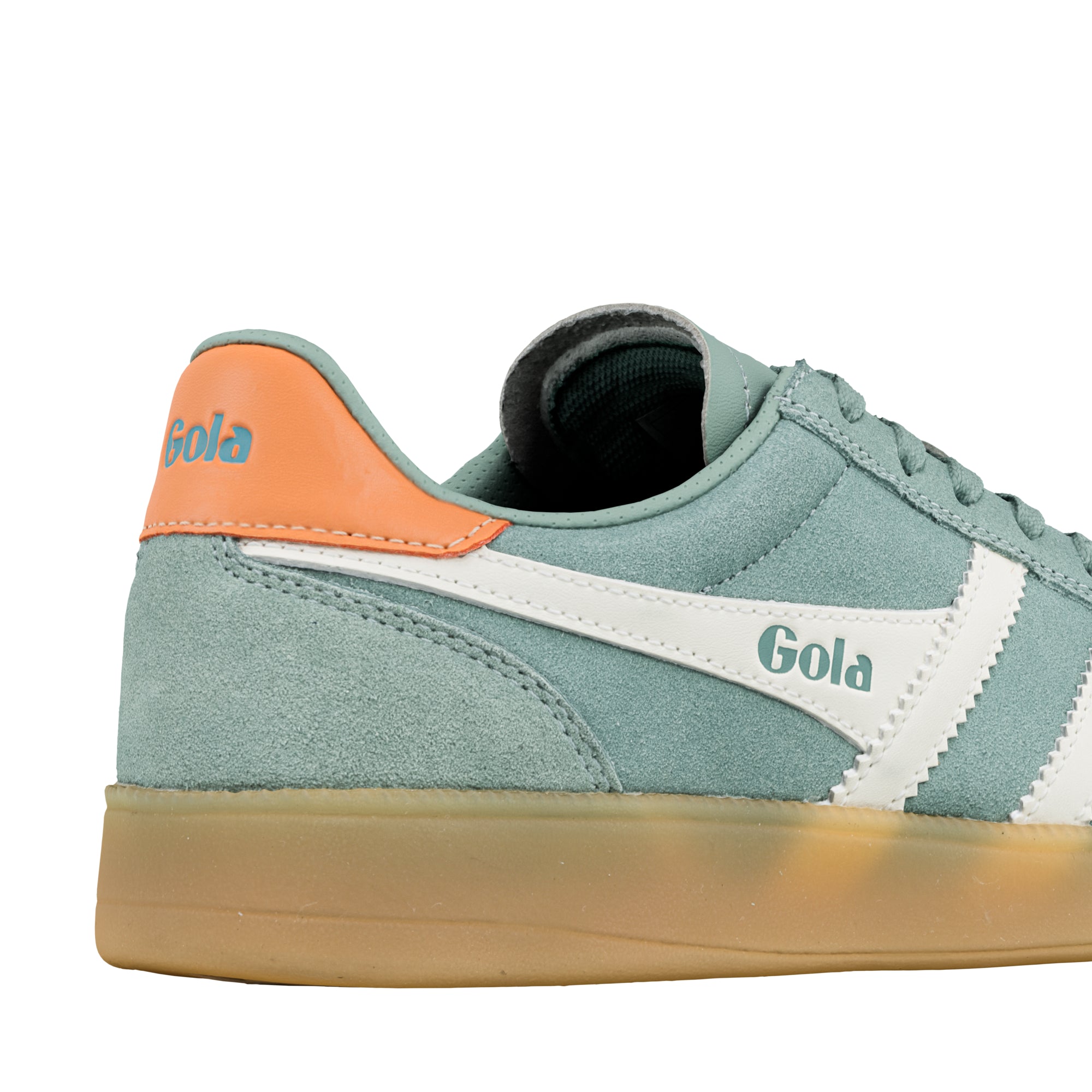 Close up of sage green suede Gola trainer with orange heel tab and gum sole