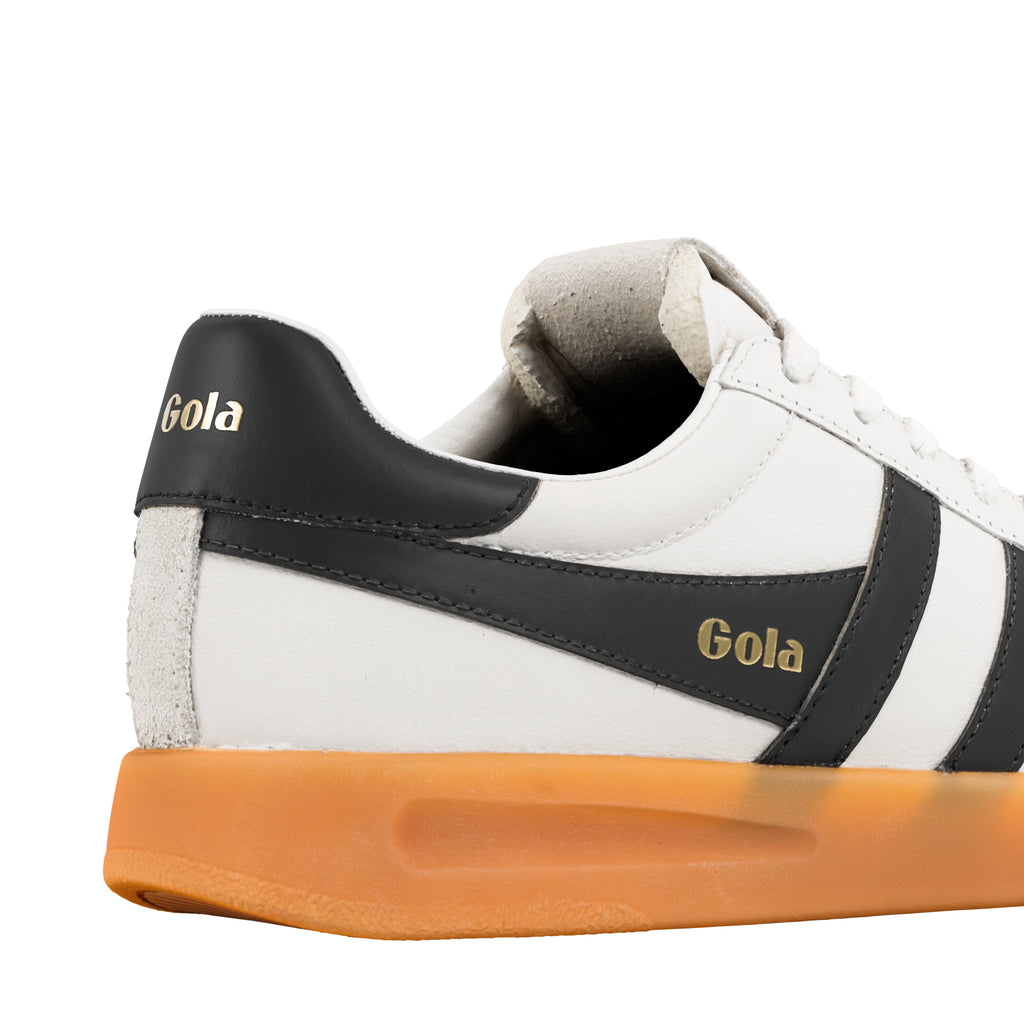 Close up of white and black Gola trainer with gum sole