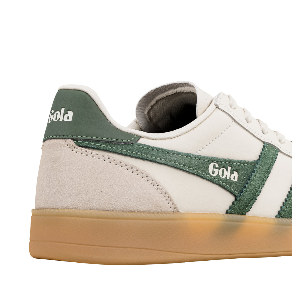 Close up of white and green Gola trainer with gum sole