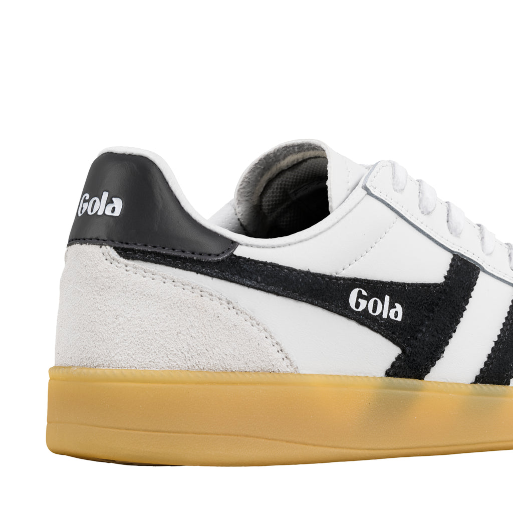 Close up of white and black Gola trainer with gum sole