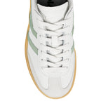White leather trainer with green side stripes and a gum rubber sole