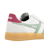 Rear view of a white Gola trainer with a pink heel tab and green suede side panel on a gum sole