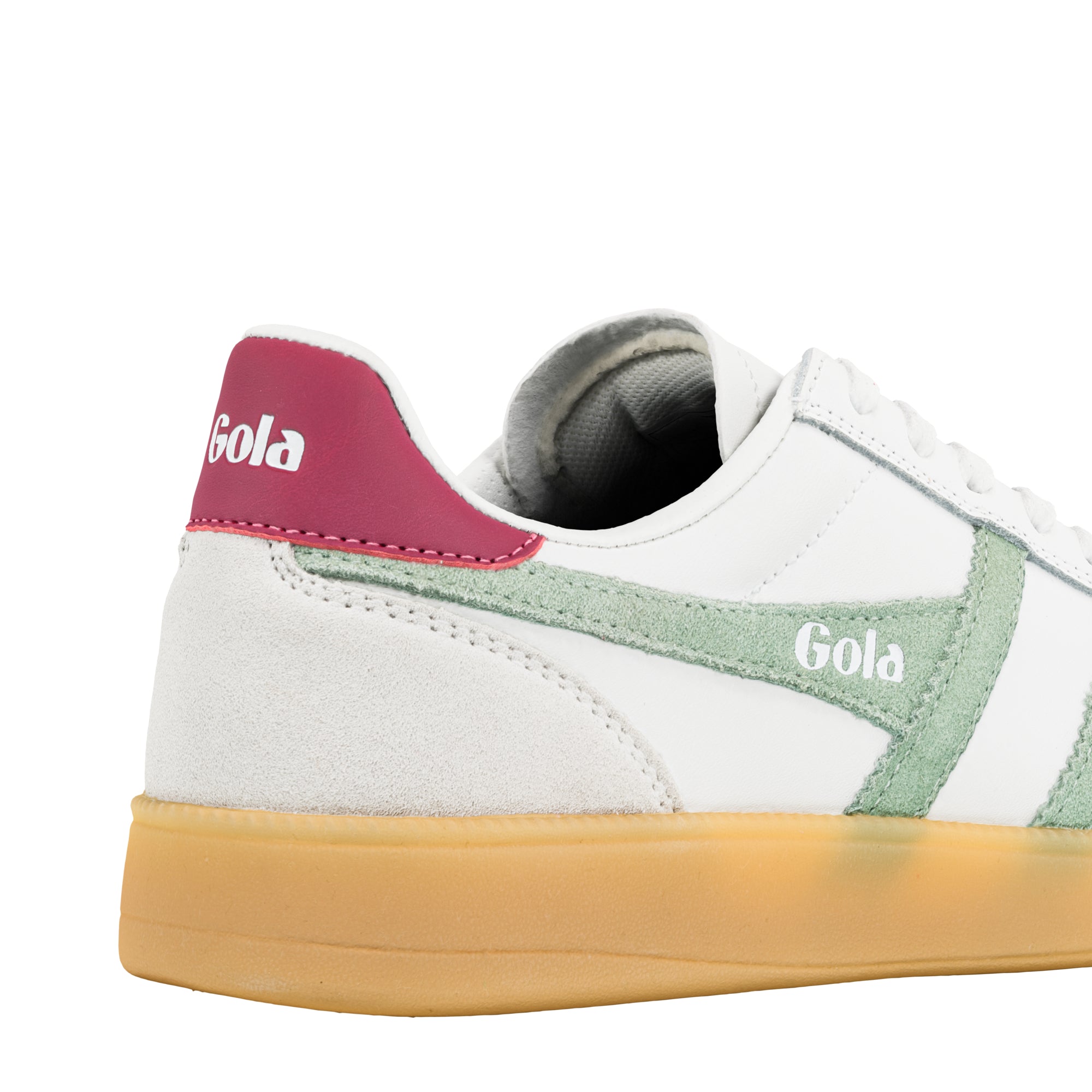 Rear view of a white Gola trainer with a pink heel tab and green suede side panel on a gum sole