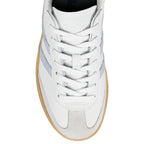 Top view of a white leather trainer with suede detailing and a gum rubber sole