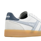 Close up of white Gola trainer heel with blue suede detailing and gum rubber sole