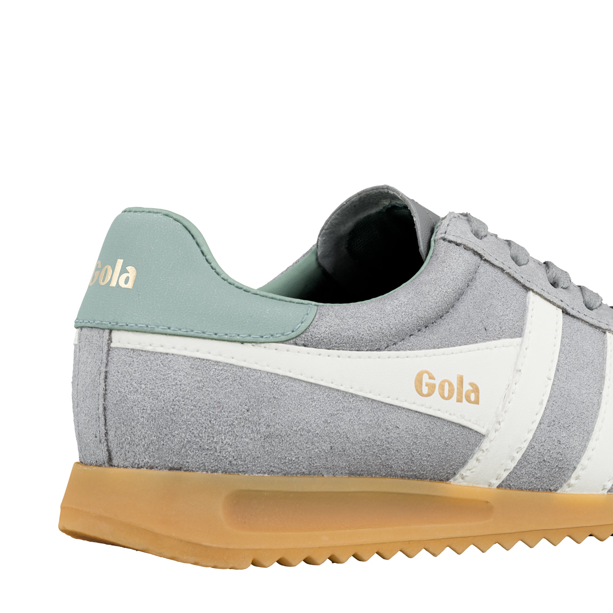 Close up of grey suede Gola trainer with sage green heel tab and gum sole