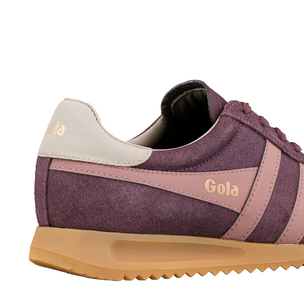 Close up of a purple suede Gola trainer with pink stripes and a gum sole