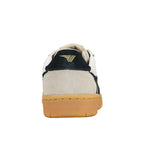 Rear view of a beige and navy suede trainer with a gum rubber sole