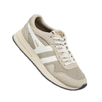 Beige Gola trainer with white side stripes and lace up fastening