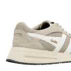 Close up of the heel and side panel of a beige Gola trainer with white detailing