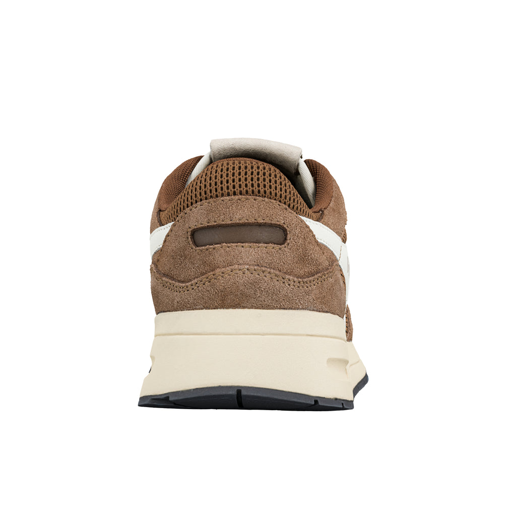 Rear view of a brown suede trainer with a cream midsole and black rubber sole