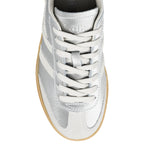 Top view of a silver metallic Gola trainer with white laces and a gum sole