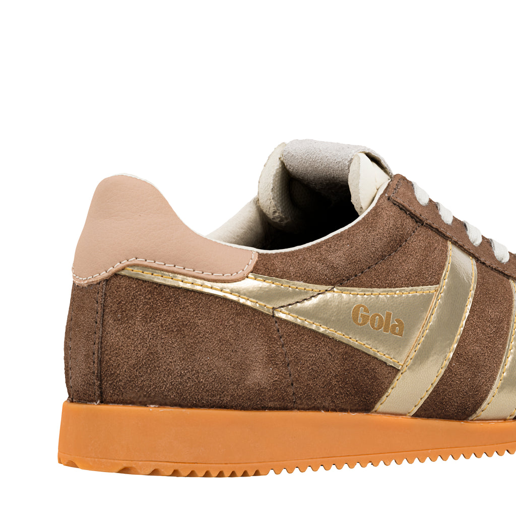 Close up of brown suede Gola trainer with gold side panels and orange sole